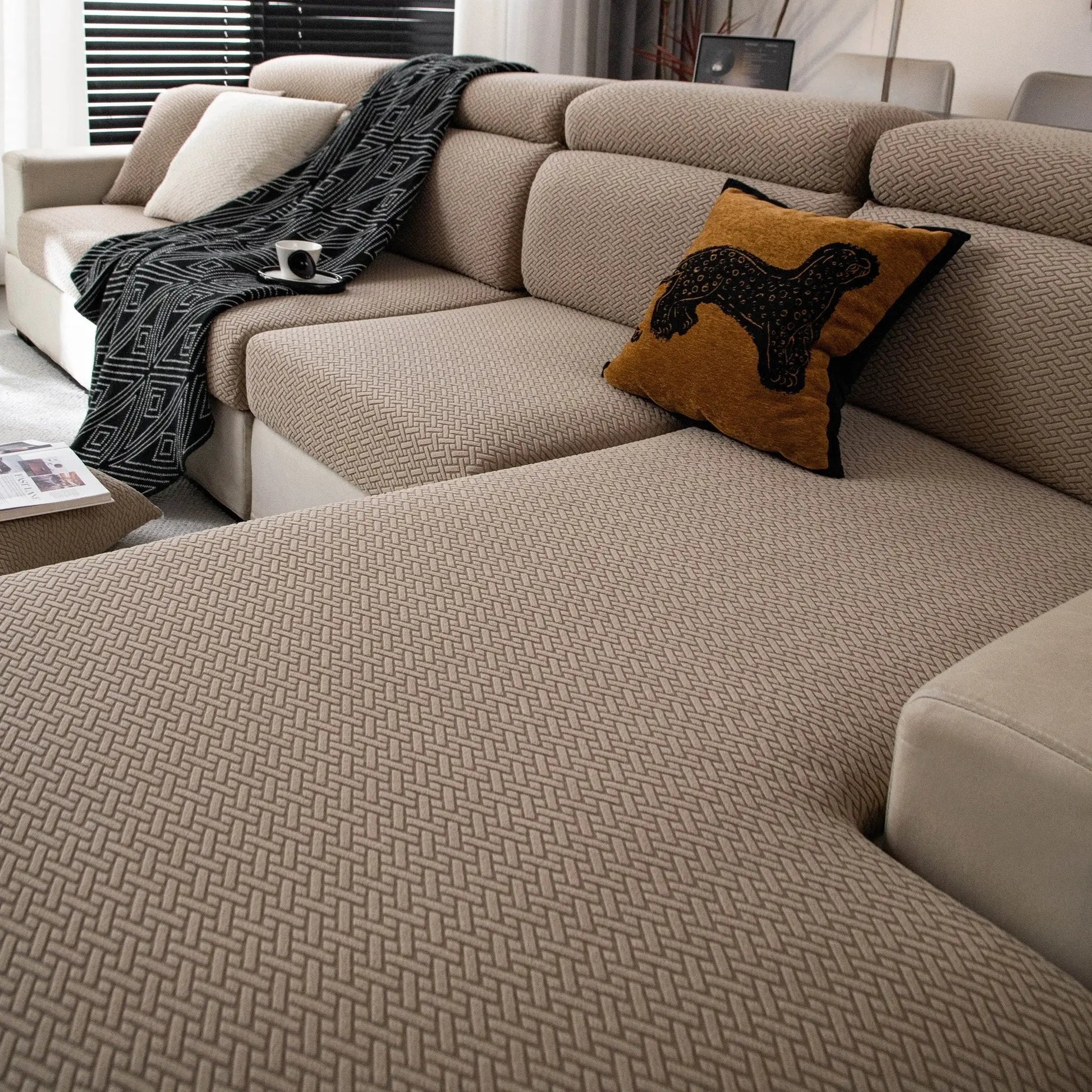 Beige polar fleece sofa cover with a woven geometric pattern; universal fit for 1–4 seat sofas.