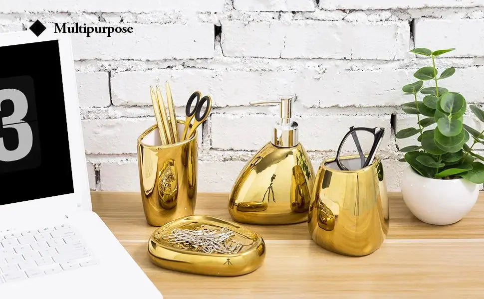 Gold metallic bathroom accessory 4-piece set: soap dispenser, toothbrush holder, mouthwash cup, and tray.