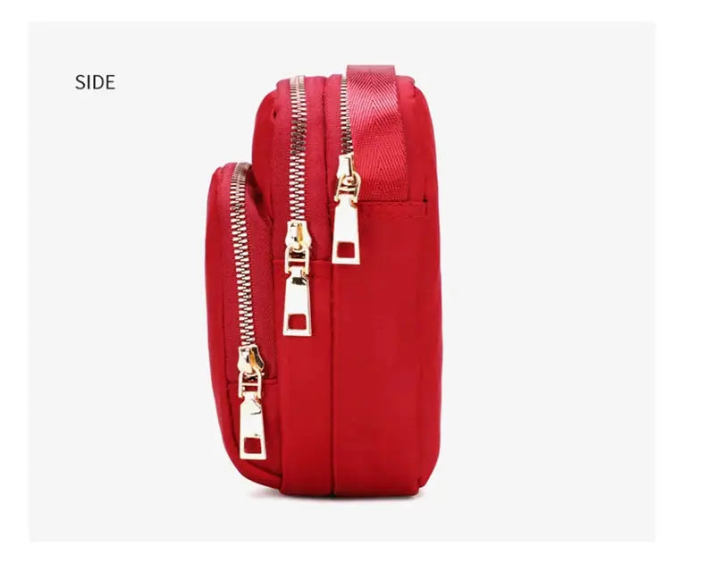 Red women's crossbody bag with gold zippers and multiple compartments