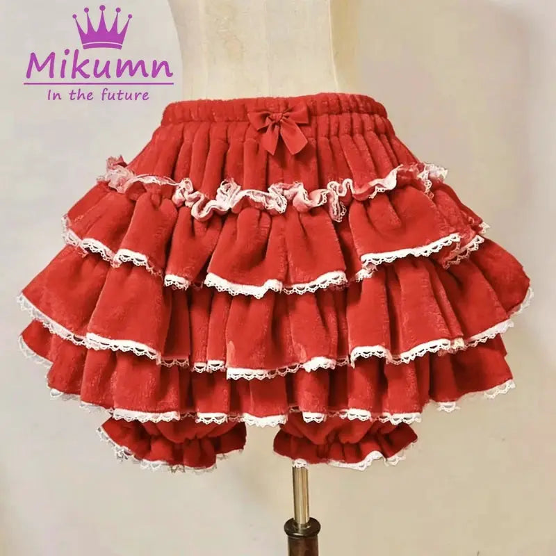 Red tiered ruffle lantern shorts with white lace trim and bow at the waist
