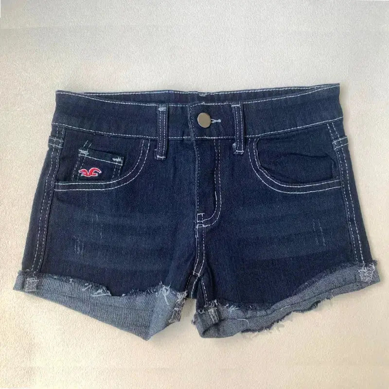 Women's dark-wash denim shorts with frayed hems, front pockets and metal button closure