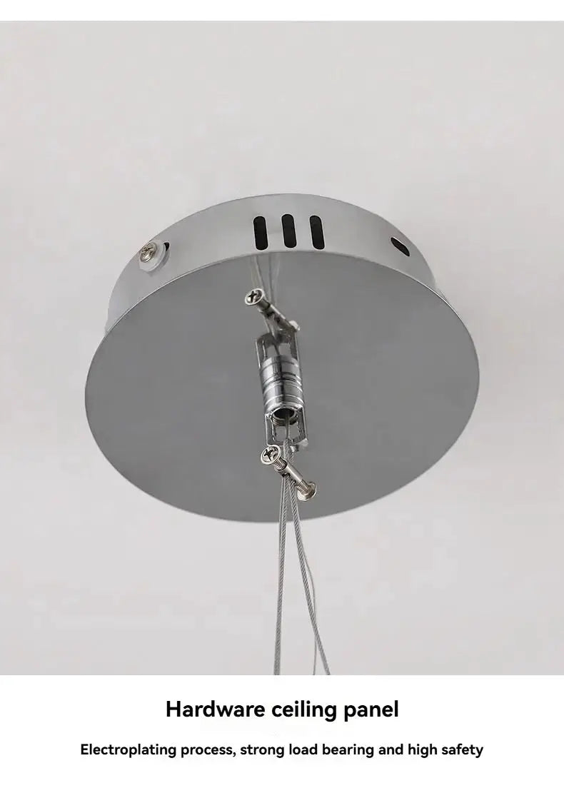 Hardware ceiling panel with round metal canopy and adjustable hanging cables.