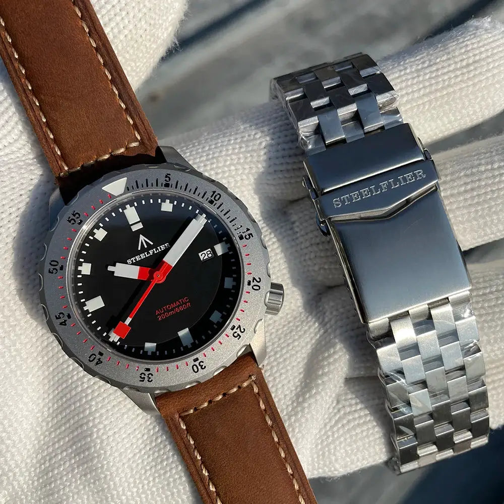 STEELFLIER SF752 mechanical dive watch with black dial and date; red seconds hand, leather strap, stainless bracelet.