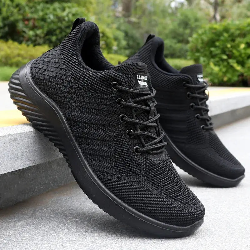 Pair of men's black casual sneakers with breathable knit upper, lightweight running and walking shoes