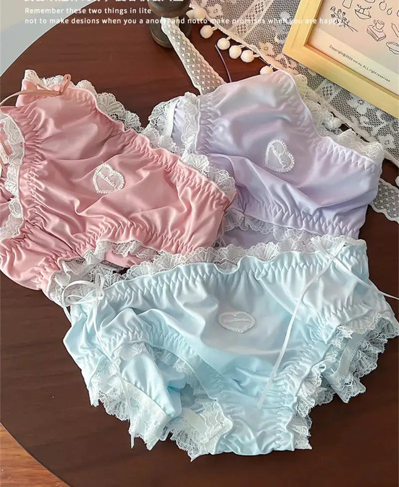 Plus-size lace panties set in pink, lavender, and baby blue with white lace trim and heart embroidery.