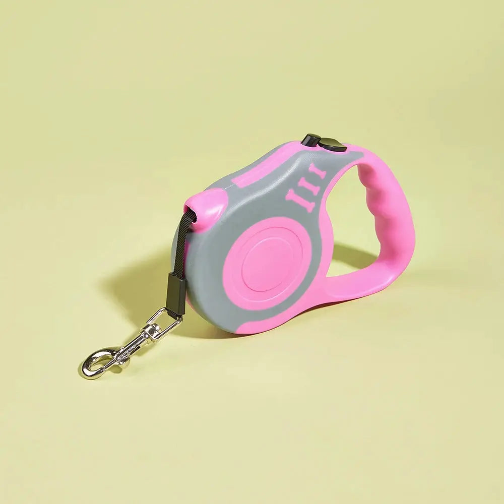 Retractable nylon dog leash, pink handle with gray housing and metal clip