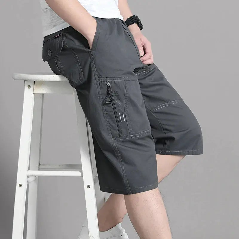 Men's cargo shorts knee-length, dark gray cotton with zippered side pocket and elastic waistband.