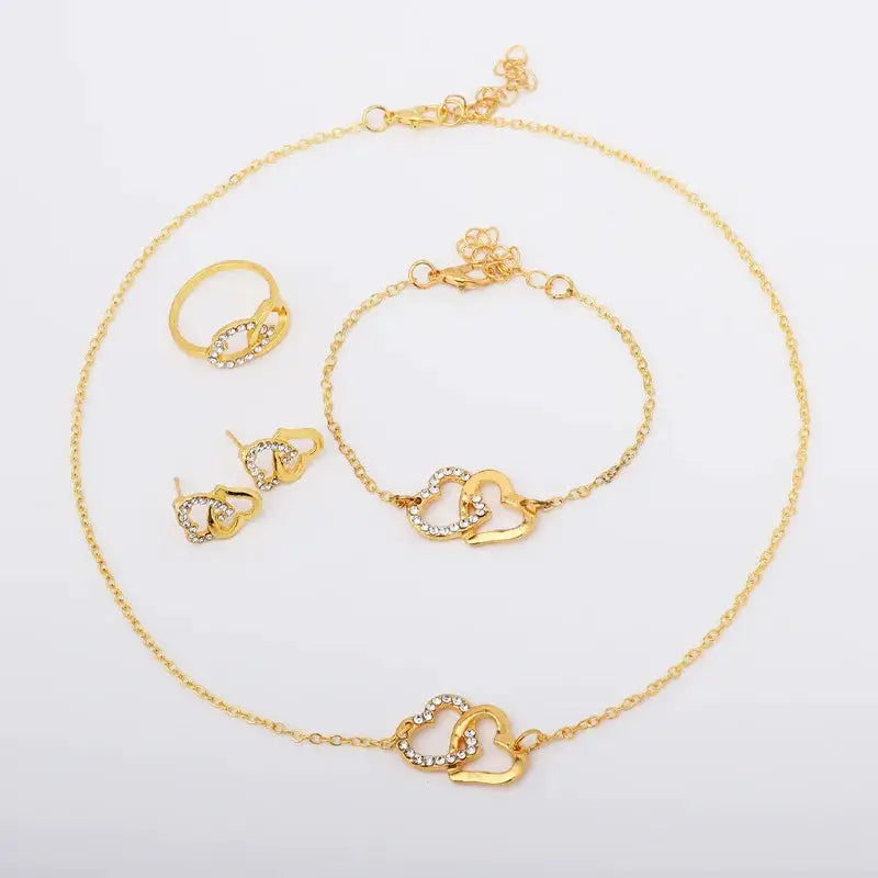 Five-piece gold-tone heart-shaped jewelry set for women with rhinestones: necklace, bracelet, ring, and a pair of earrings