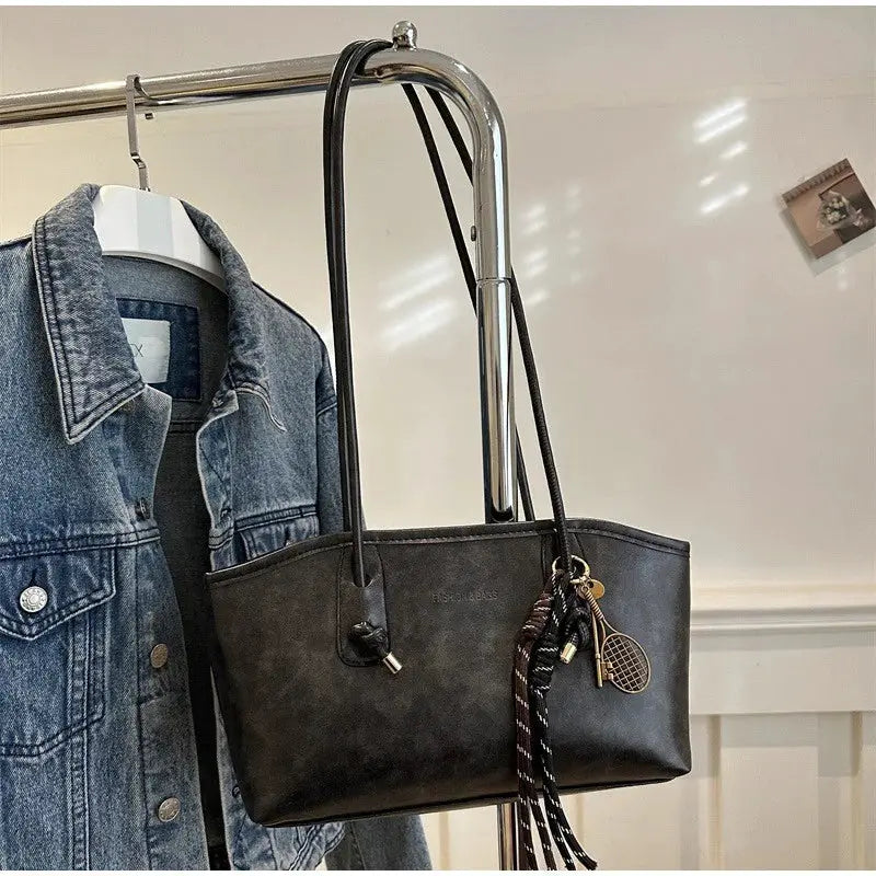European American retro tote bag in black faux leather with long shoulder straps and pendant charms