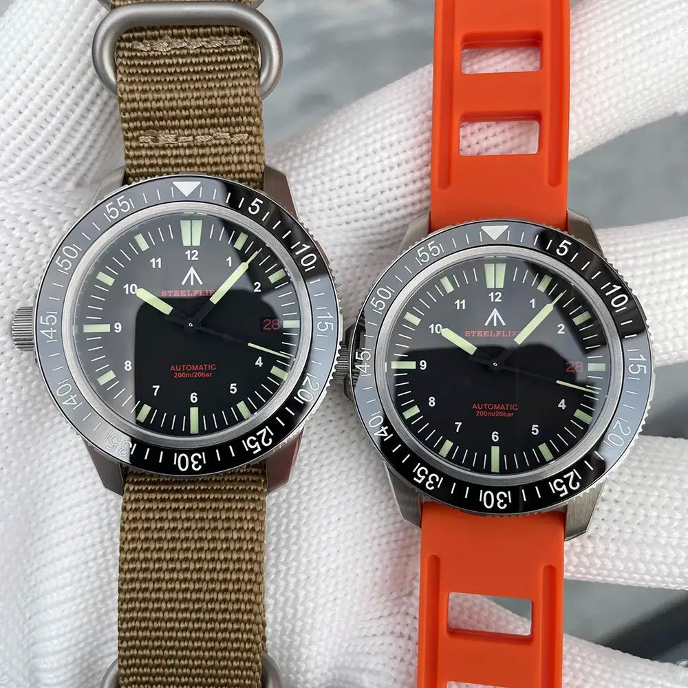Two STEELFLIER SF783 dive watches with black dials, ceramic bezels; brown canvas and orange silicone straps.