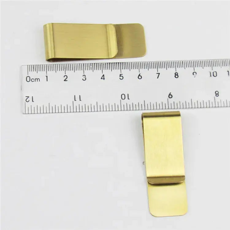 Gold-toned money clips (2) shown with ruler for scale, Simples Market.