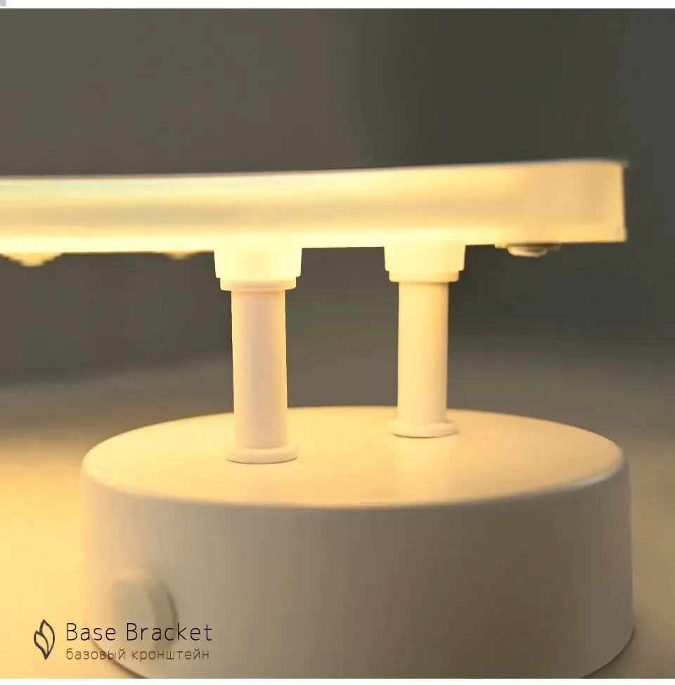 Base Bracket white LED wall lamp with dual posts and a round base, warm glow