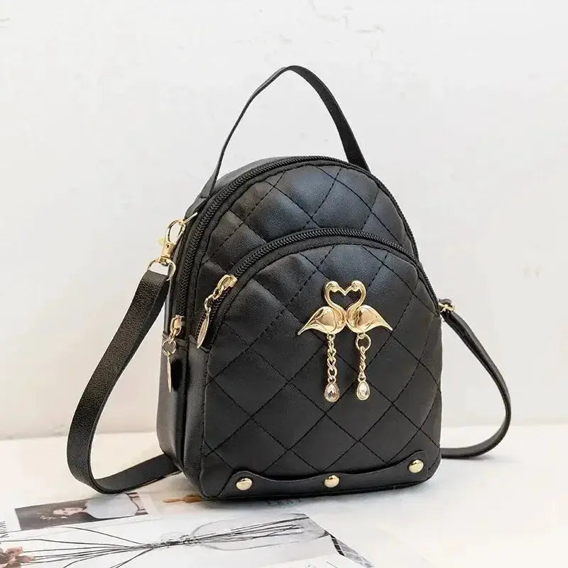 Fashion women's mini backpack in black quilted faux leather by Simples Market with gold-tone hardware.