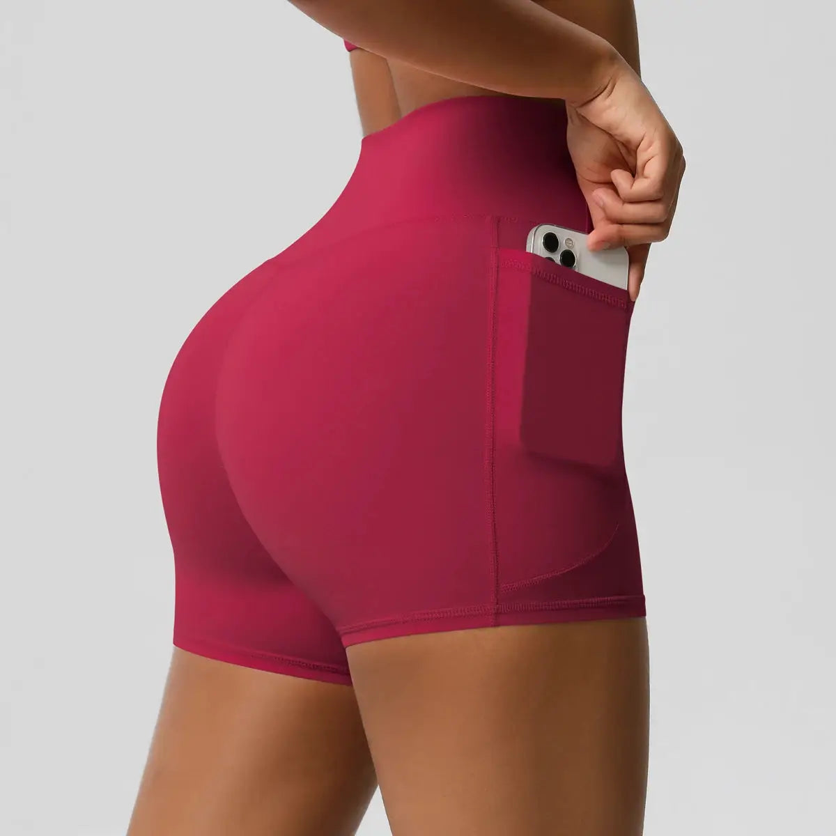 Women's pocketed high-waist sport shorts in magenta, quick-dry, compression-fit for gym and cycling