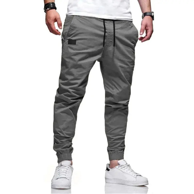 Men's gray cargo jogger sweatpants with drawstring waist, multiple pockets and cuffed ankles