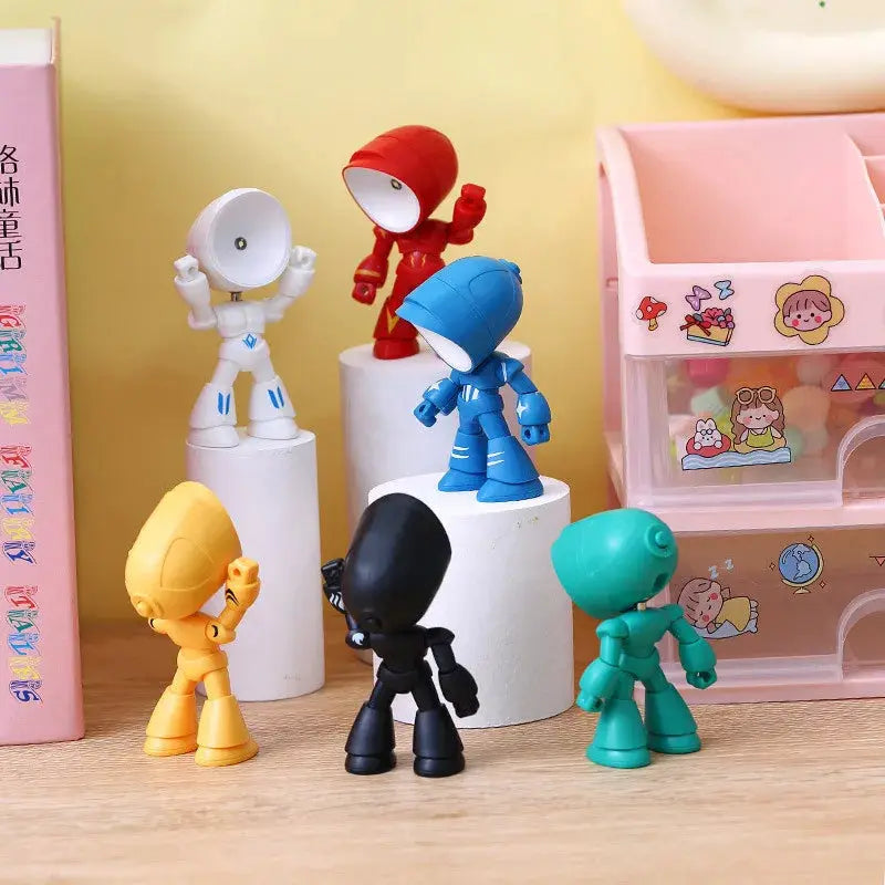 Mini LED night light set: six cartoon hero robot figures in white, red, blue, yellow, black and teal on white pedestals.