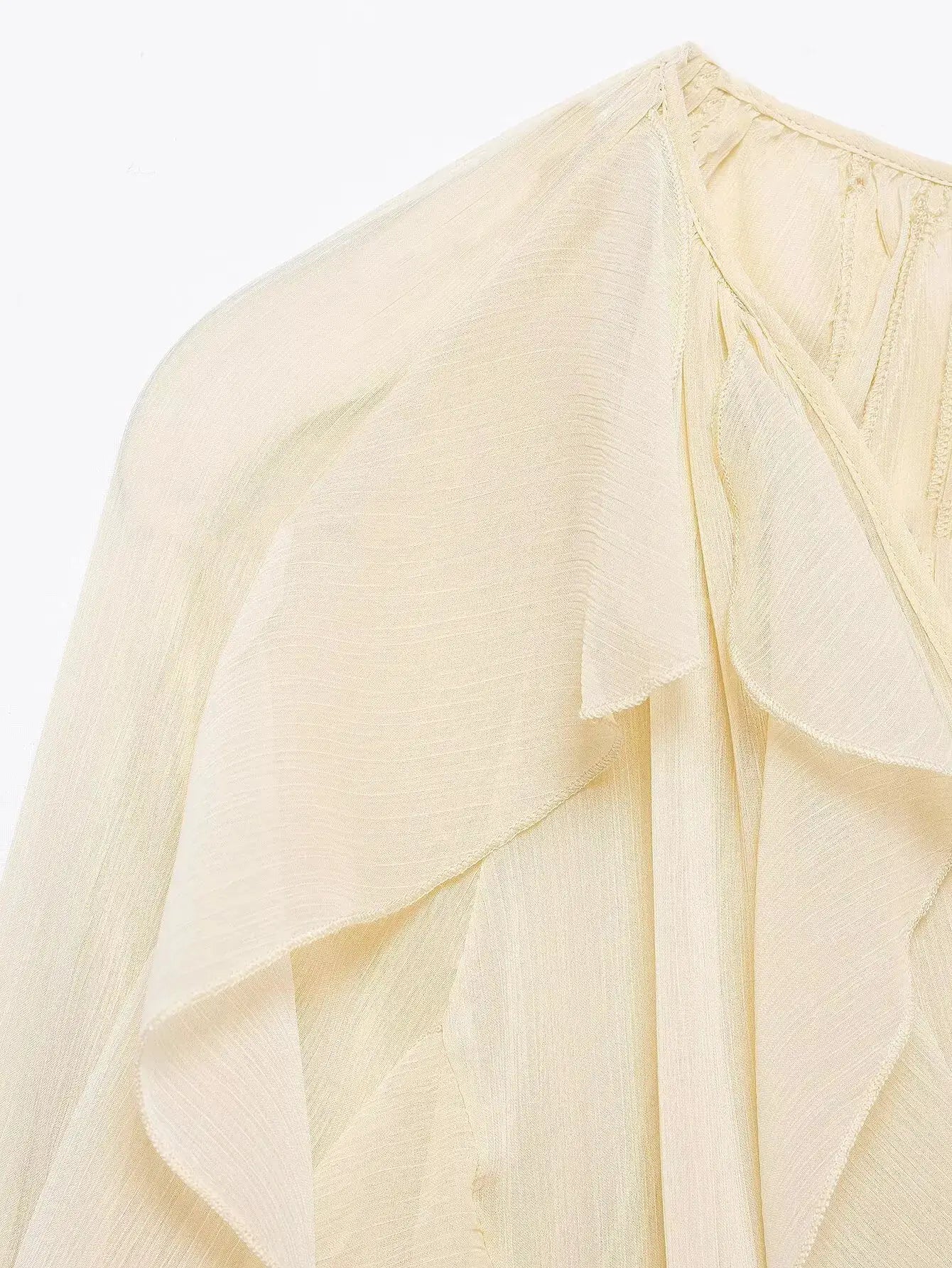 Women's cream chiffon blouse with ruffle trim and draped layers