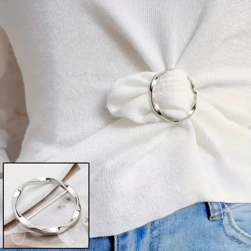 Clip buckle ring for shawl or waist; round silver metal ring securing a white top.