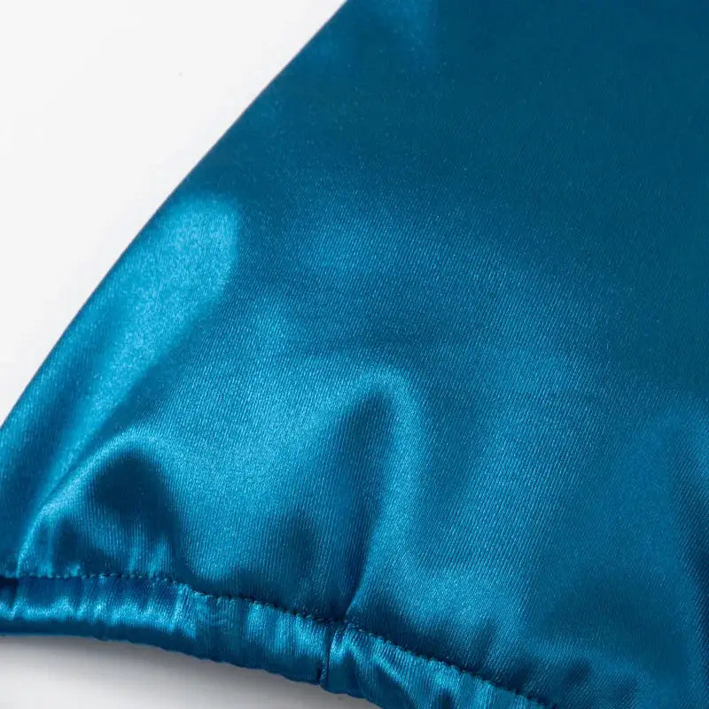 Halter bikini fabric close-up in blue metallic satin