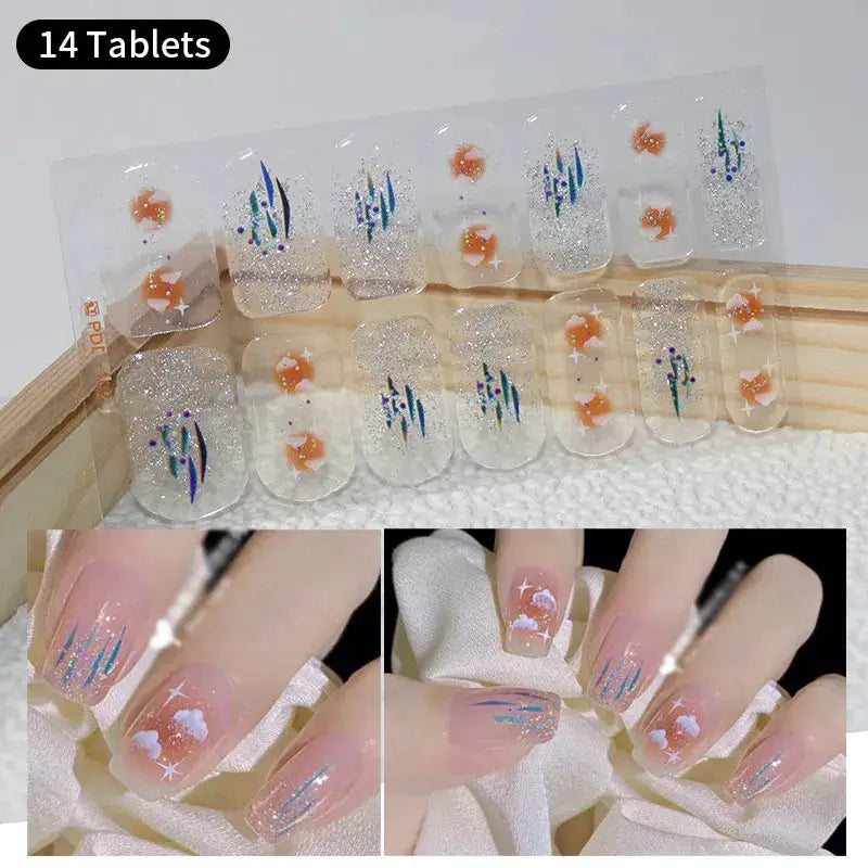 Full cover nail stickers by Simples Market, 14 clear glitter tablets with orange flowers and blue accents.