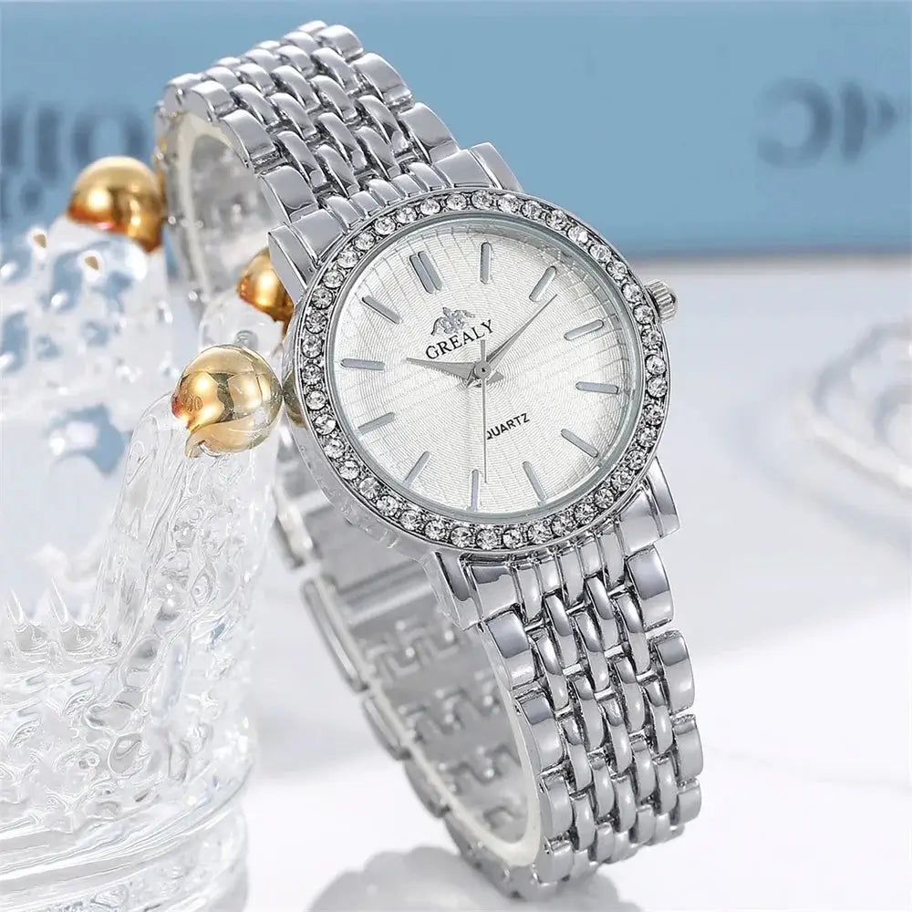 Women’s silver quartz watch with round dial, rhinestone bezel, and metal link bracelet