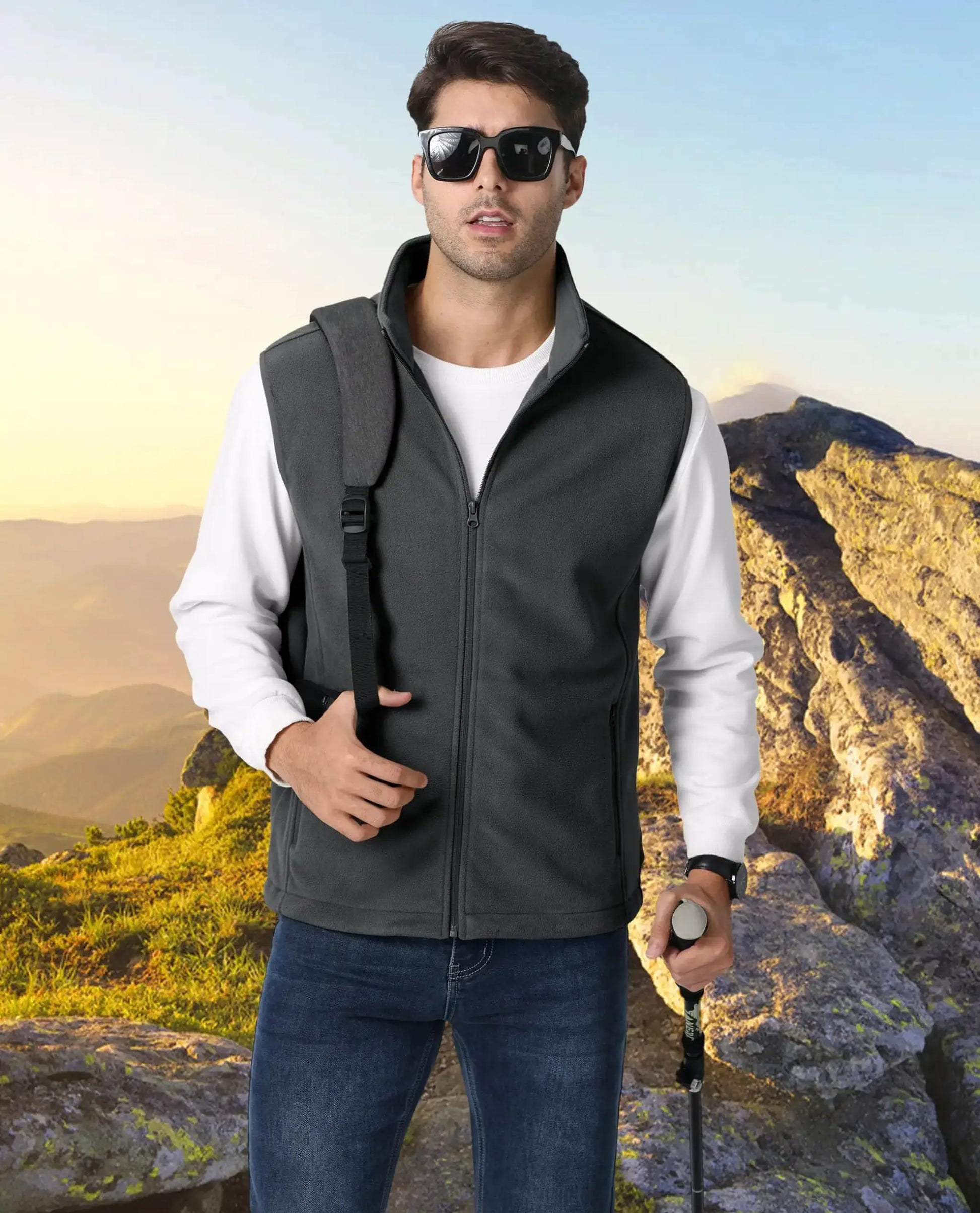 TACVASEN men's fleece vest sleeveless with stand collar in dark gray, outdoor hiking scene.