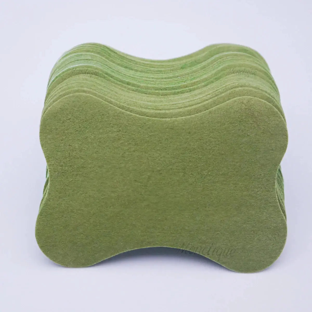 Lumbar spine self-heating patches by Simples Market, green bone-shaped pads stacked