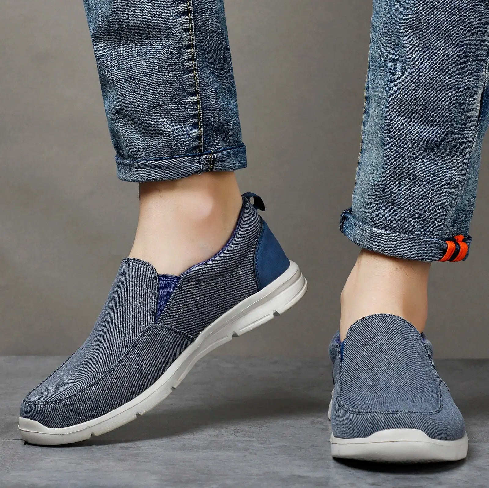 Pair of men's blue canvas slip-on sneakers by Simples Market with white soles