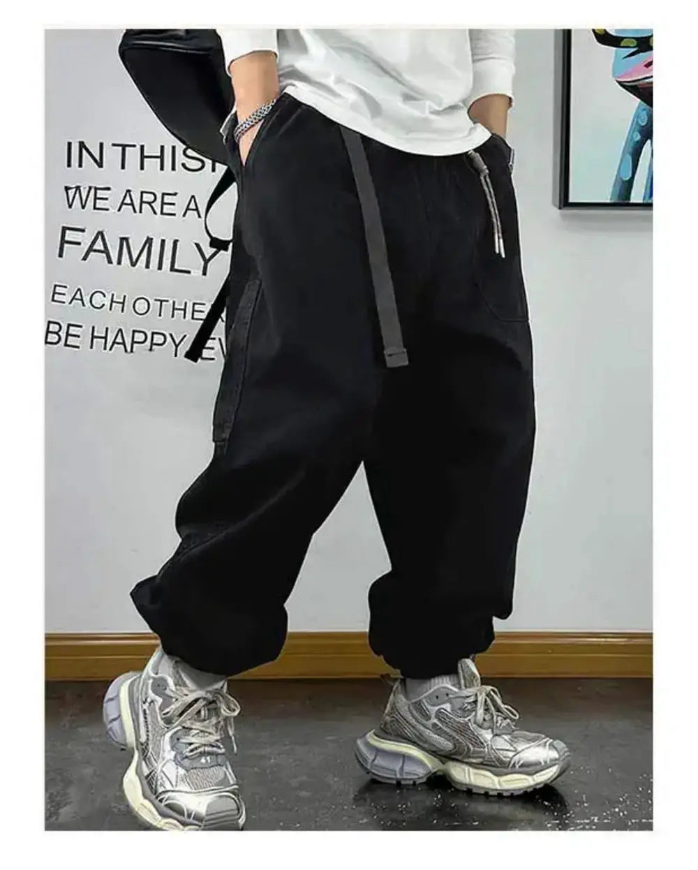 Baggy cargo pants in black with multiple pockets and drawstring waist, Japanese streetwear style.