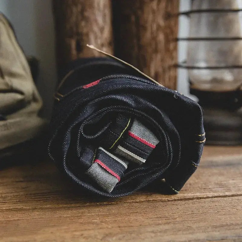 Maden Retro raw denim jeans, 14.5oz selvedge in dark indigo, rolled to reveal red/white selvedge edge