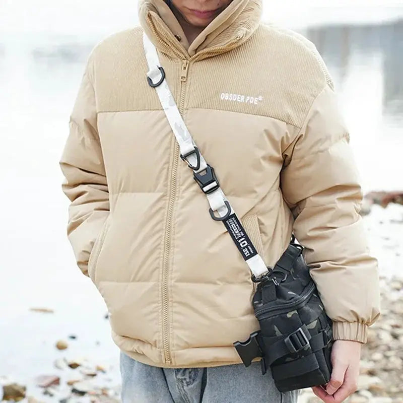 Crossbody strap for backpacks; adjustable, tactical storage strap with white camo pattern, shown with beige jacket.