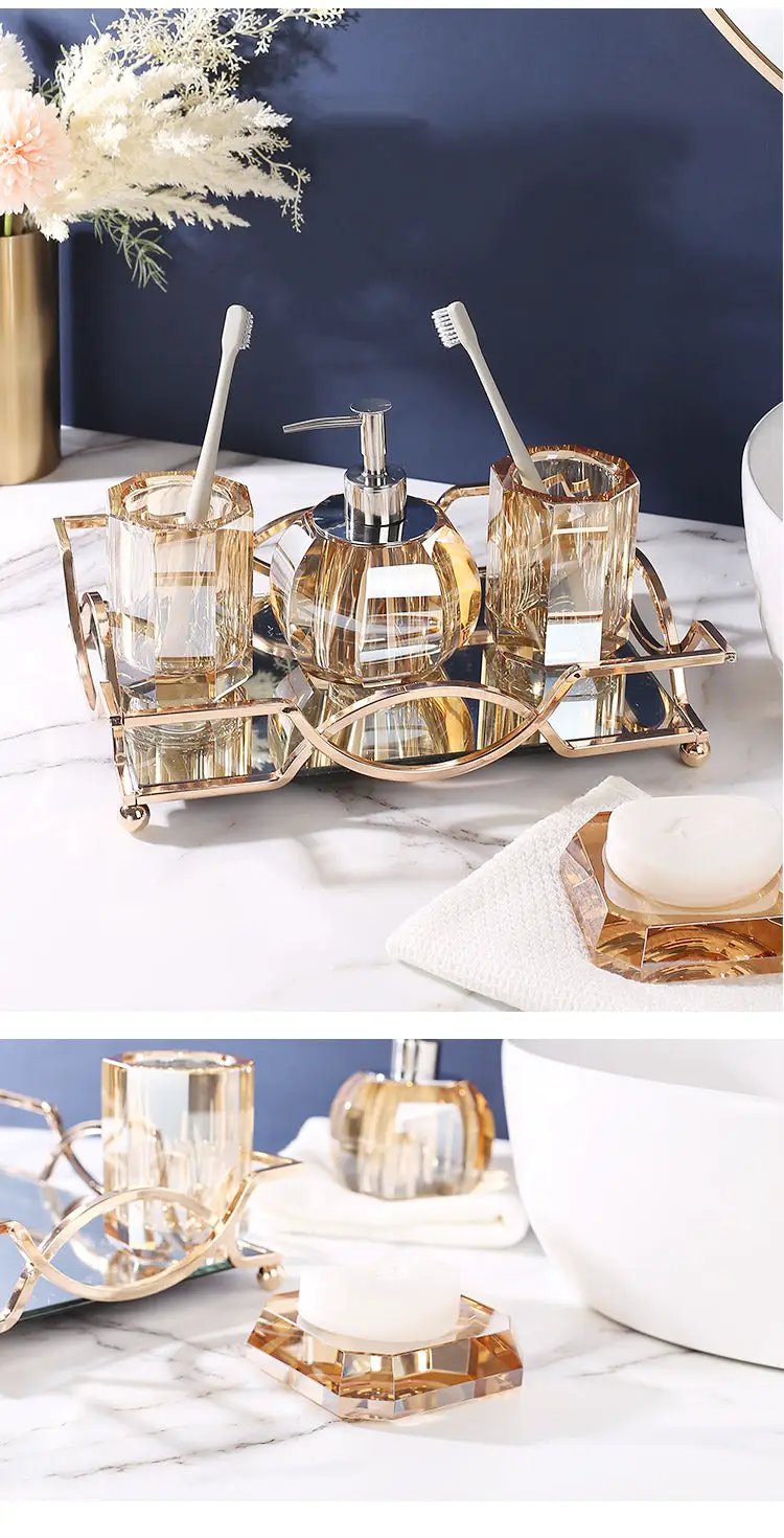 Glass bathroom set by Simples Market with two amber crystal toothbrush holders, lotion bottle and soap dispenser on a rose-gold rack