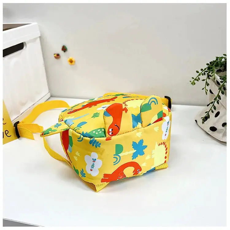 Kids yellow dinosaur backpack with colorful prints and adjustable straps