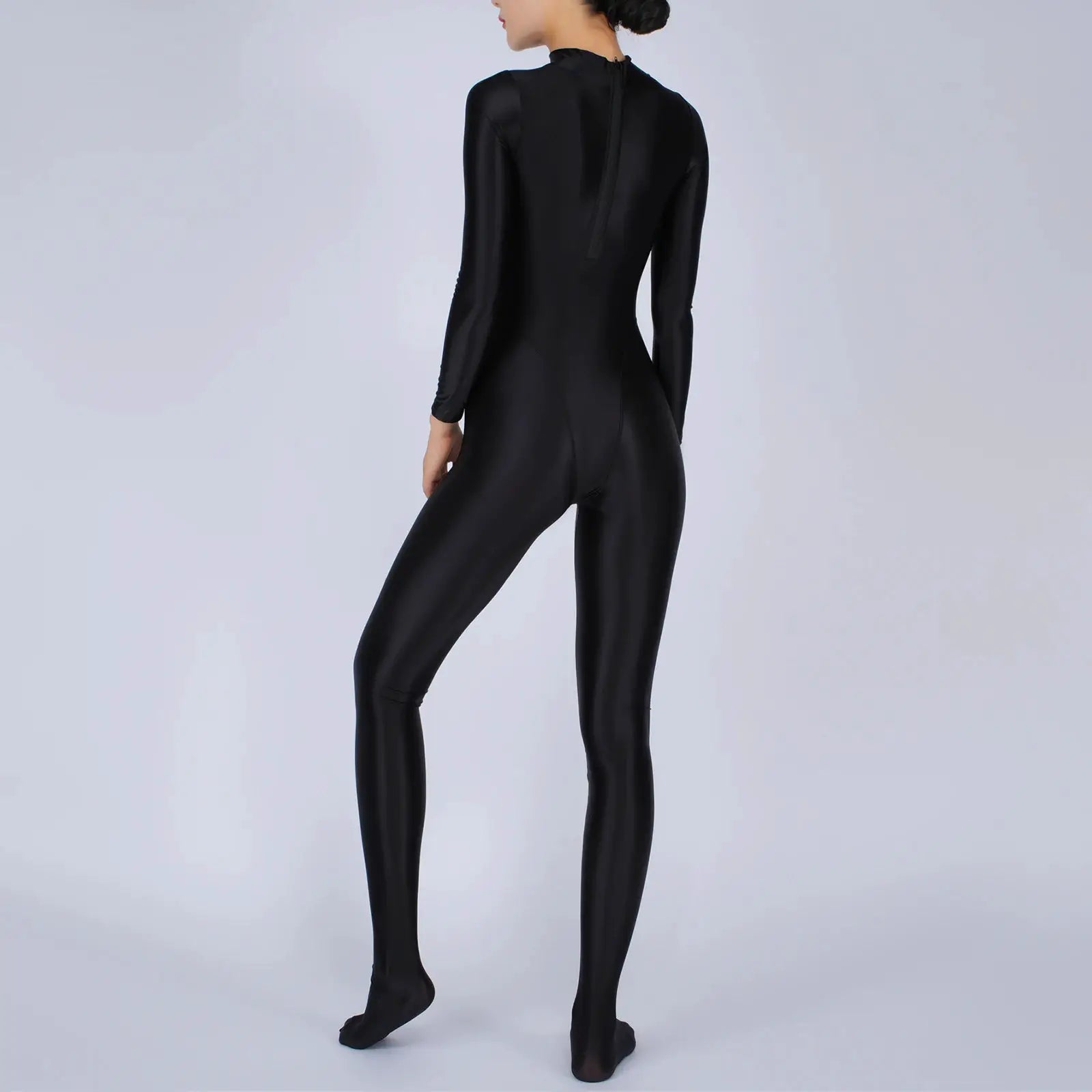 Women's black full-body jumpsuit with long sleeves and footed design, a one-piece athletic bodysuit