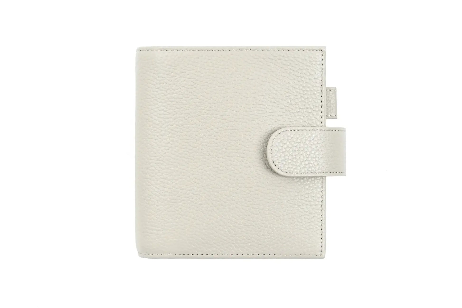 Moterm Luxe 2.0 pocket-size planner in pebble-grain cream leather by Simples Market with strap closure.
