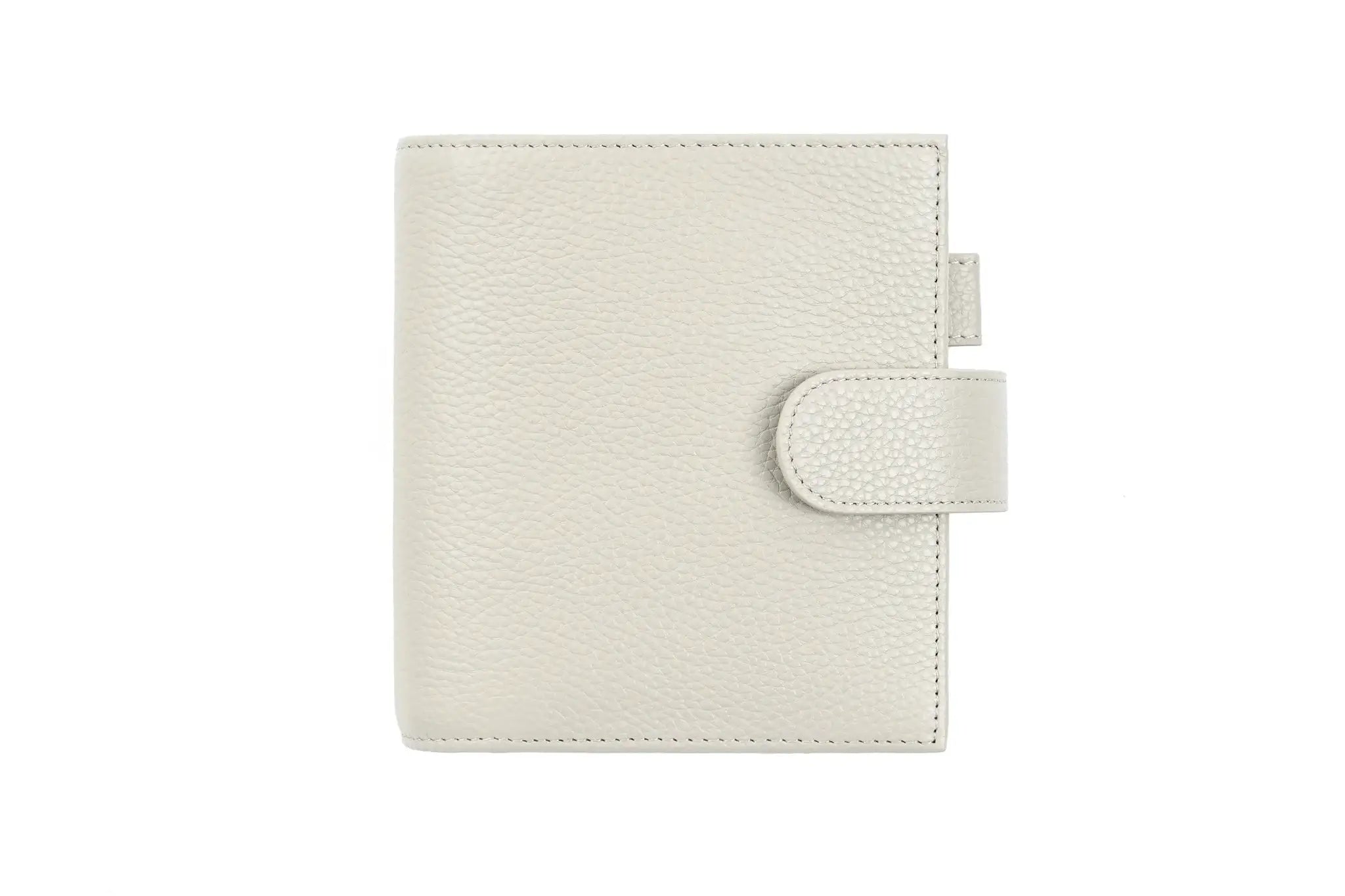 Moterm Luxe 2.0 pocket-size planner in pebble-grain cream leather by Simples Market with strap closure.