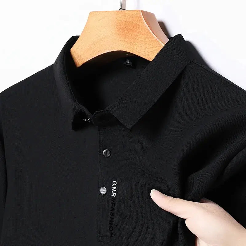 Men's black polo shirt, short sleeves, solid color with button placket, on hanger.