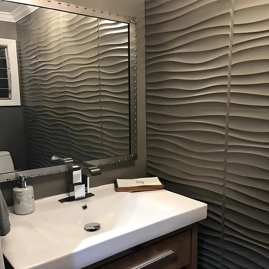 Simples Market 3D textured wall panels in grey with a wavy pattern, 30x30 cm, installed in bathroom beside a mirror.