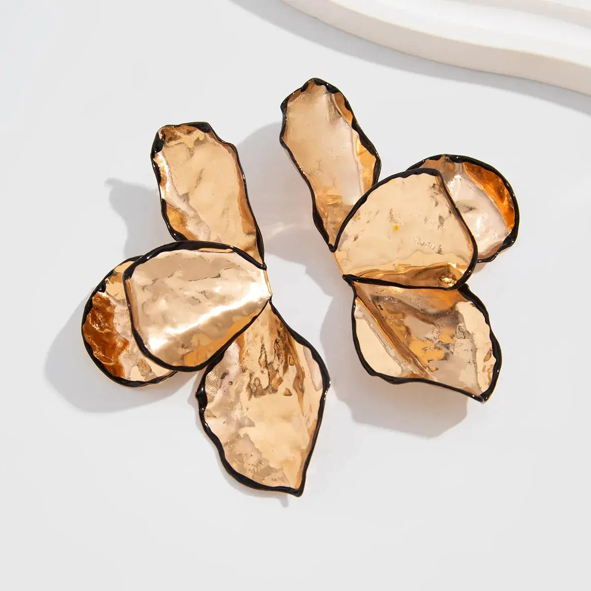 Petal earrings for women by Simples Market; metallic rose-gold, irregular pleated petals, oversized floral design.