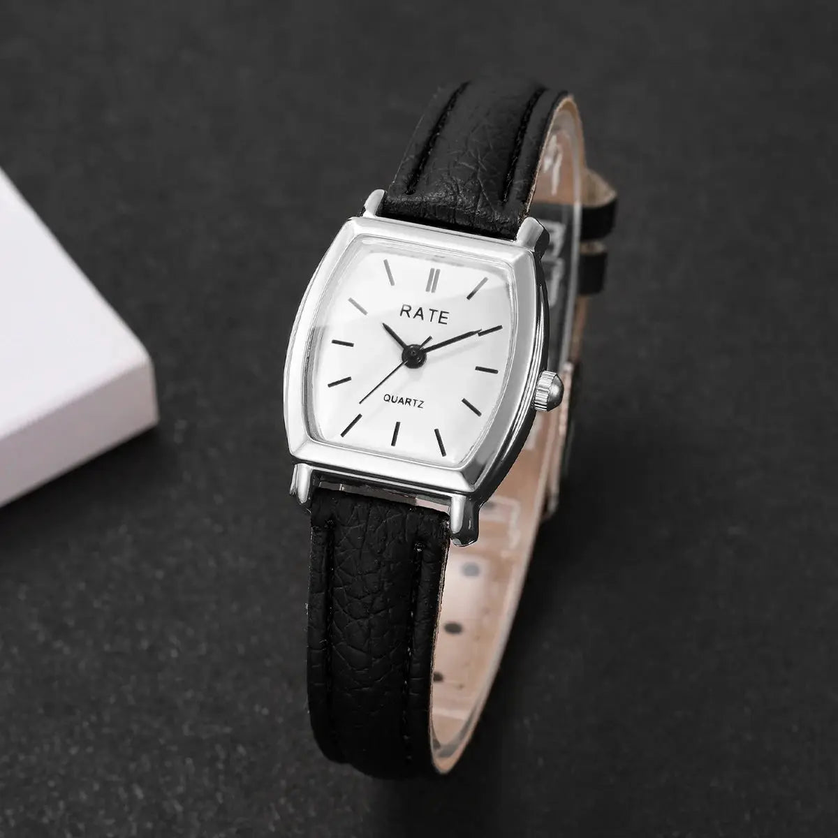 Women's watch with black leather strap, silver-tone case, white dial, quartz movement