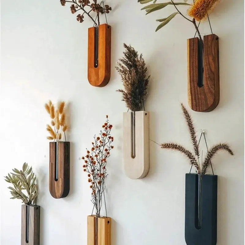 Set of seven wooden hanging planters by Simples Market, Bohemia wall vases with wood stands in assorted finishes.