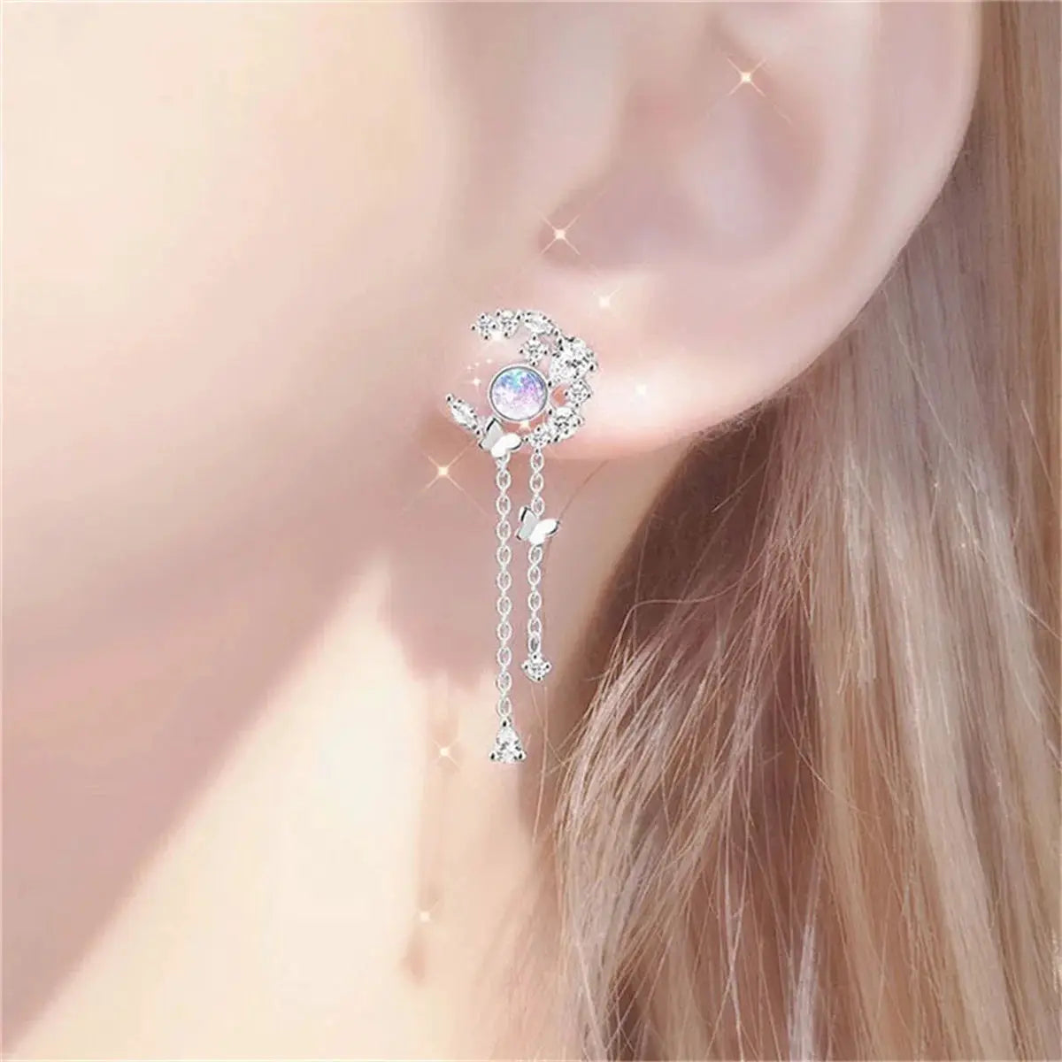 Moon-planet butterfly tassel drop earrings by Simples Market in silver-tone with crystal accents