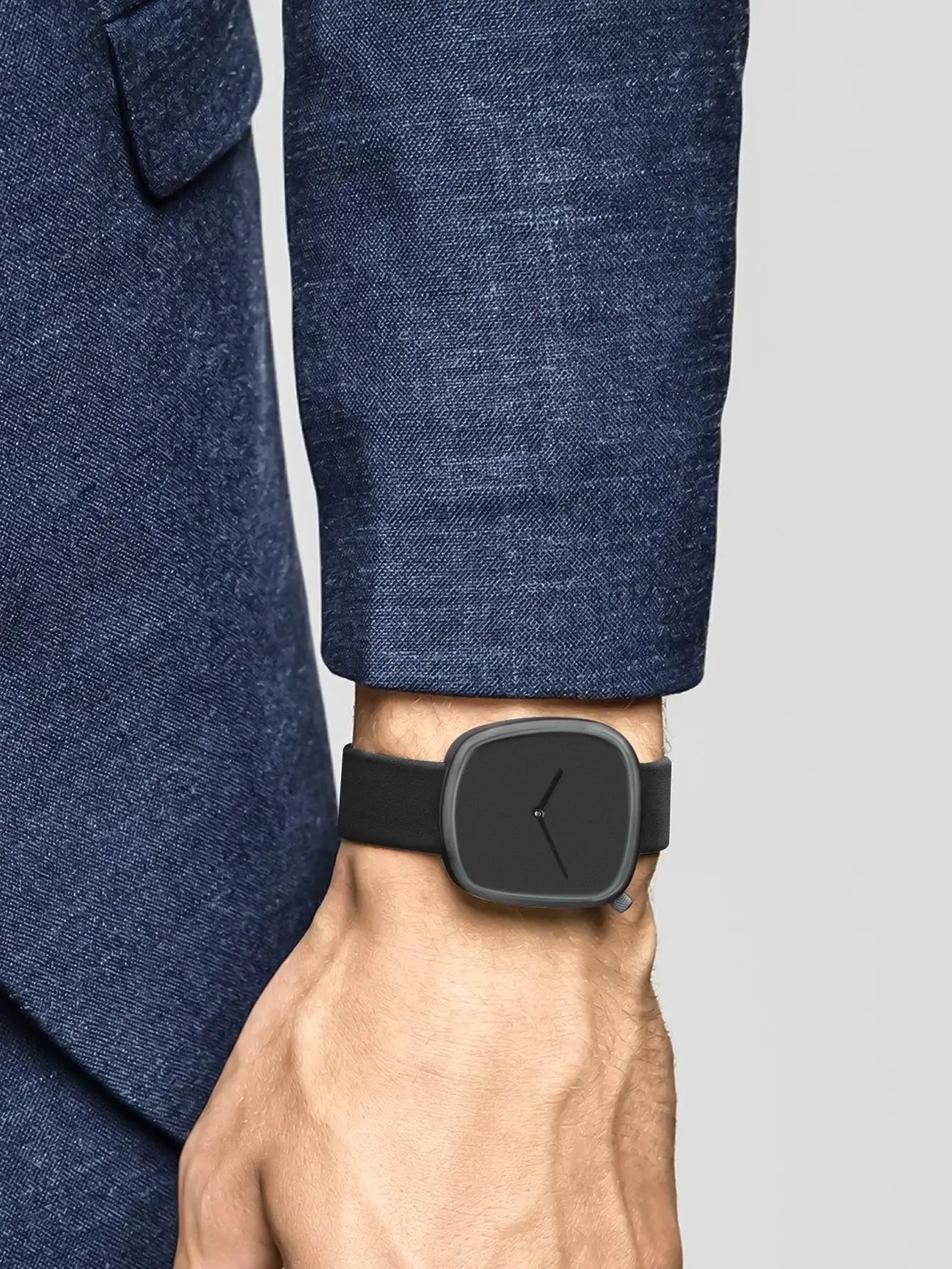 TOMI square minimalist watch on wrist with black dial and black strap