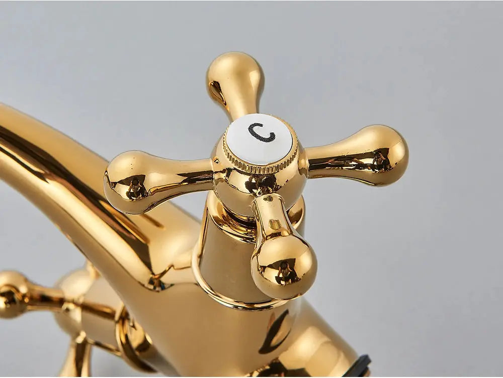 Antique gold bathroom faucet mixer with two cross handles, deck-mounted.