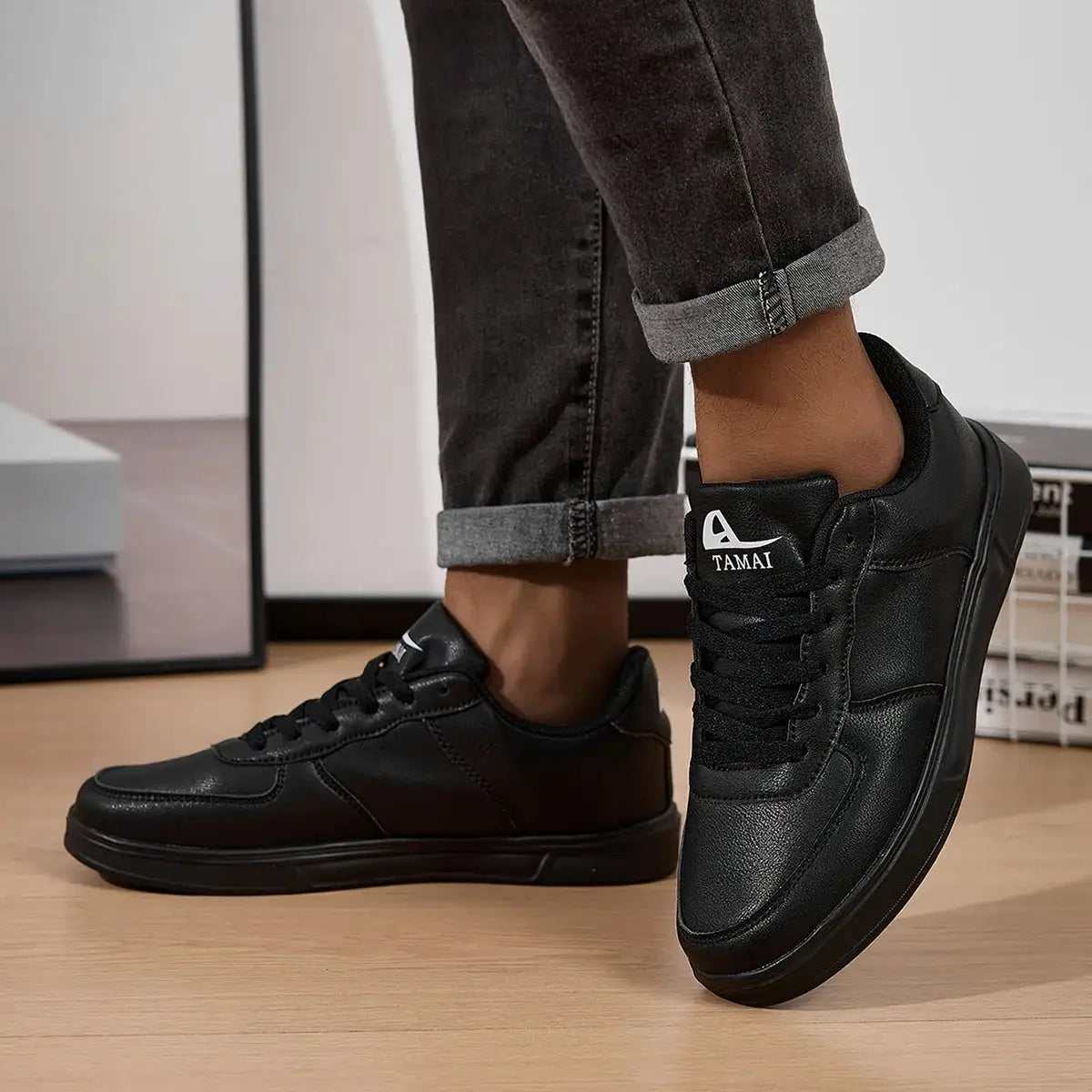 Leather men's black sneakers pair with Tamai logo on tongue, casual skate/walking shoes from Simples Market