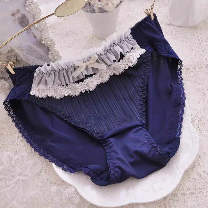 Panties navy blue with white lace trim, ruffled waistband and bow; front panel features vertical stripes, breathable.