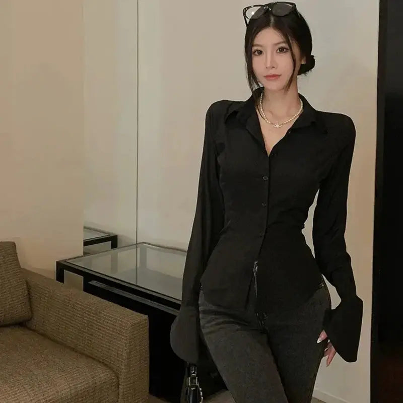 Women's black bandage blouse with bell sleeves, button-down front, fitted silhouette