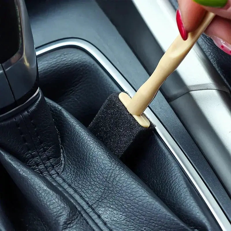 Car air vent cleaner brush by Simples Market with beige handle and black foam sponge