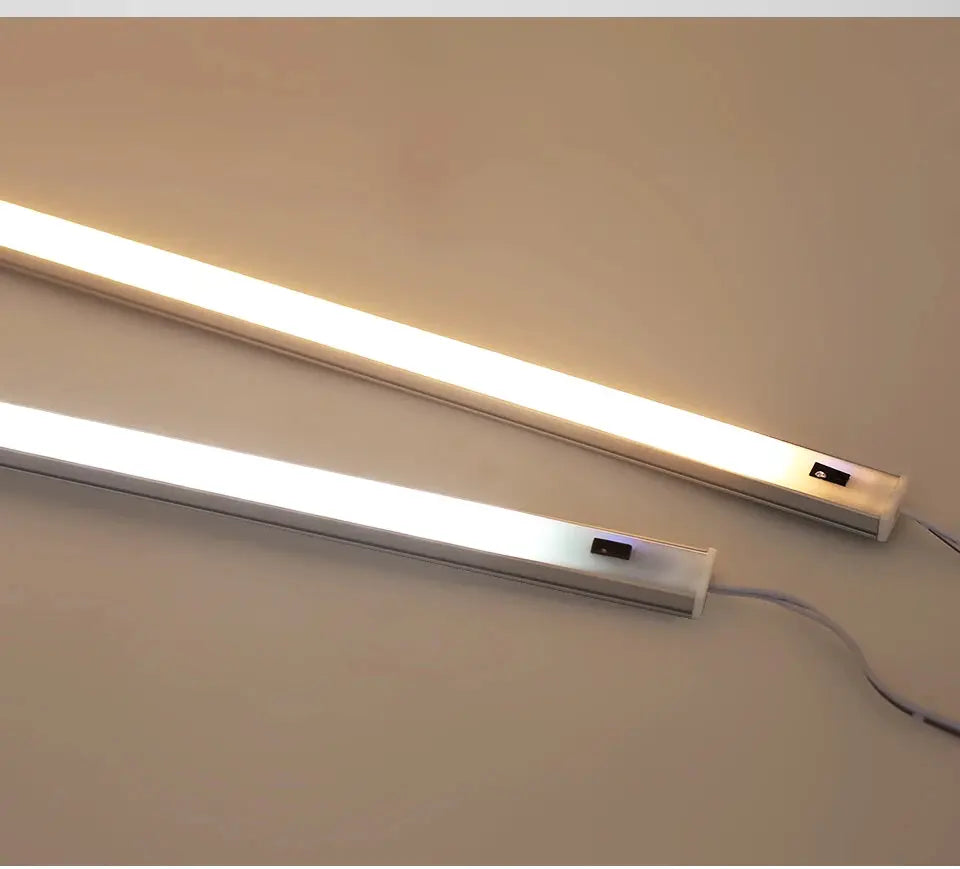 Simples Market LED under-cabinet lights; white aluminum bars with hand-sweep switch and PIR motion sensor, two bars.