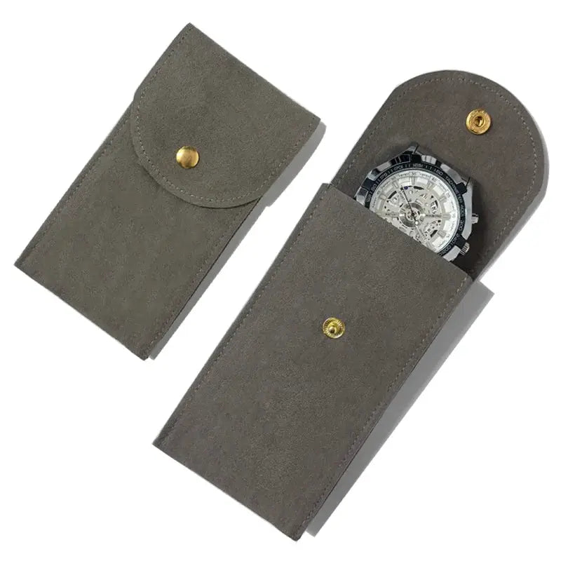 Grey suede watch case set (2) with gold snap closures for portable dust protection and storage